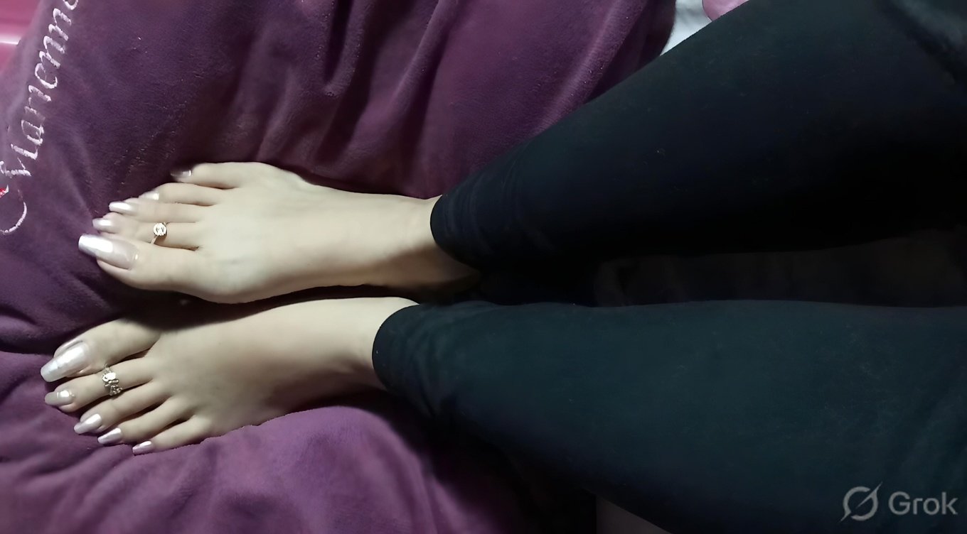 Chennai BDSM Mistress Anu showcasing elegant feet with long natural toenails in a sensual foot-focused pose