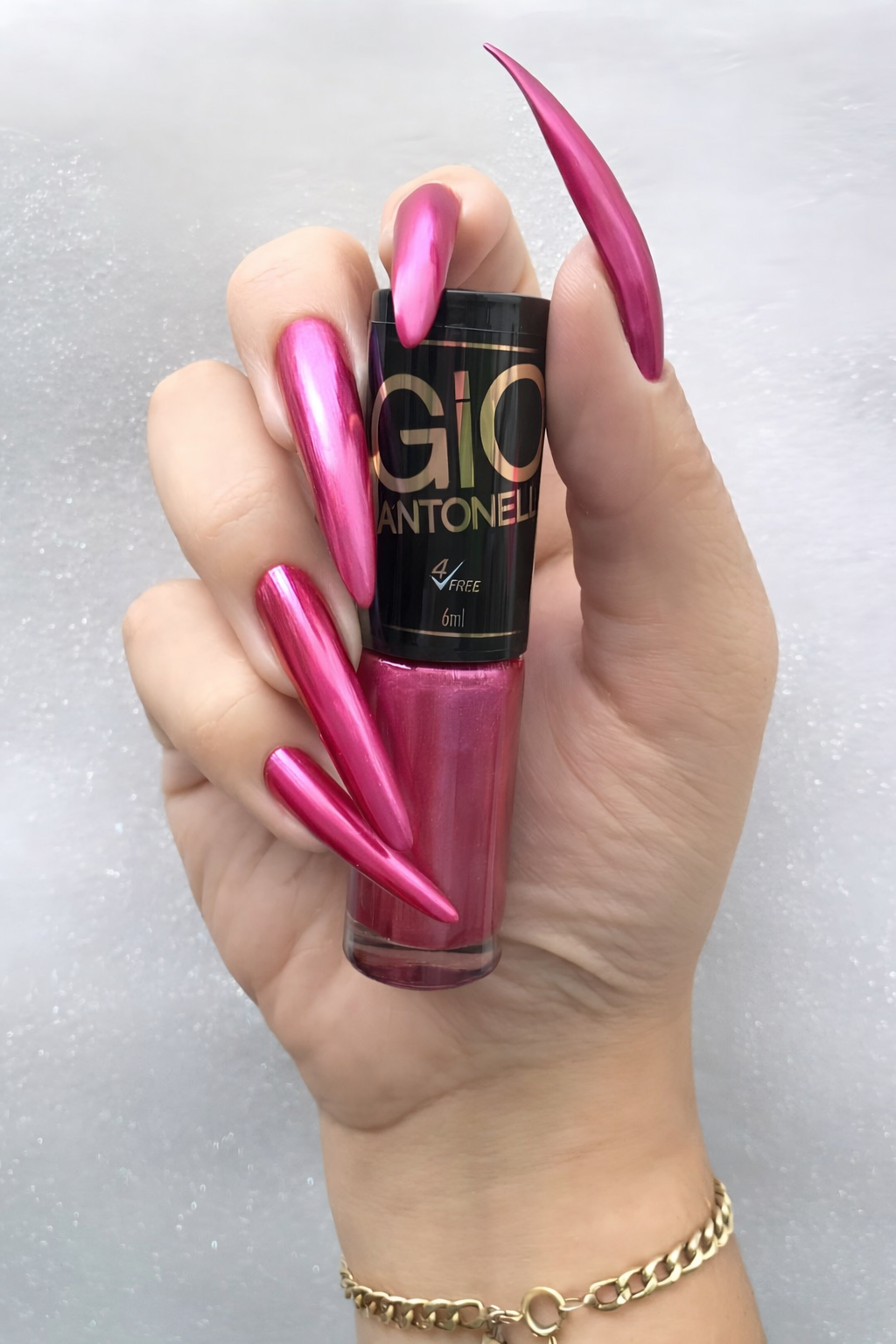 Mumbai BDSM Mistress with long metallic blue stiletto nails holding nail polish