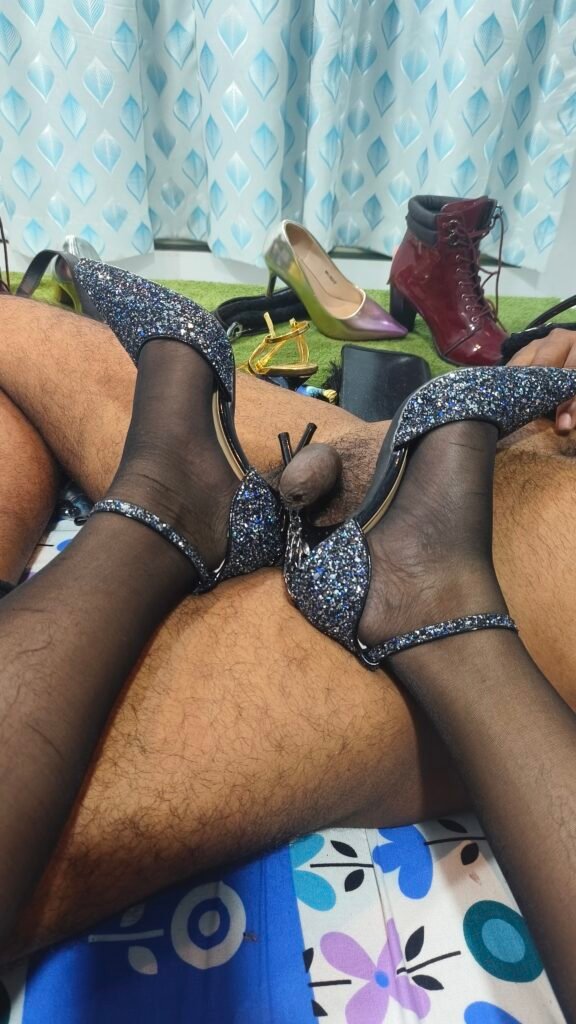 Pattaya Bdsm Mistress Anu wearing sheer black nylon stockings and sparkling blue glitter high heels during a dominant session with a male submissive.